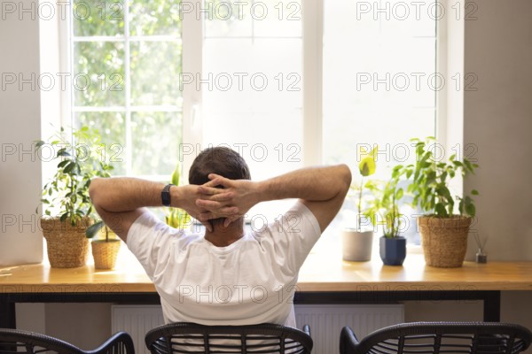 Young personal development coach answering the client by email by a laptop while having break in a