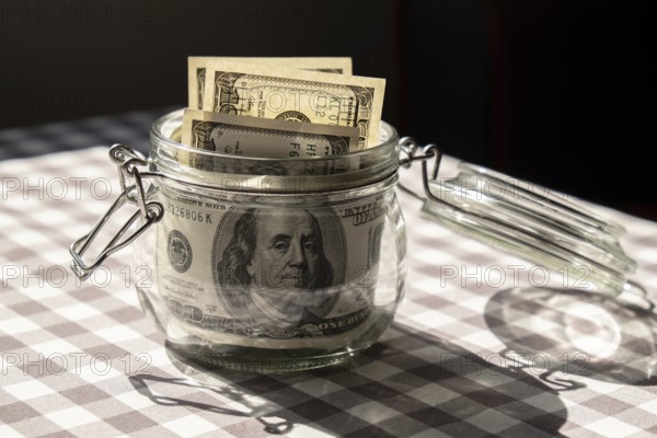 Dollar banknote saving money in glass jar. Consumption and economy Collecting money. Tips.