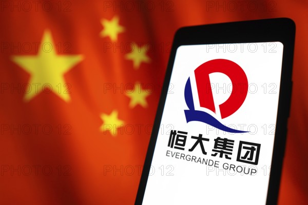 In this photo illustration, the Evergrande Real Estate Group logo is displayed on a smartphone