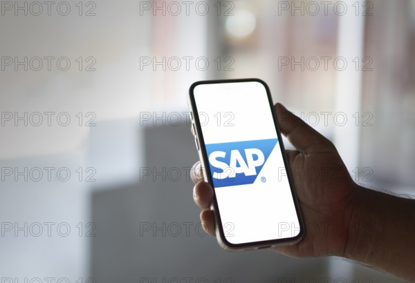 SAP SE logo is displayed on smartphone. SAP SE is a German multinational software company based in