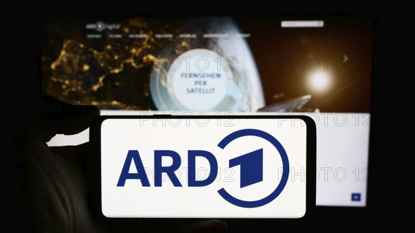 Stuttgart, Germany, 04-10-2024: Person holding cellphone with logo of German public-service