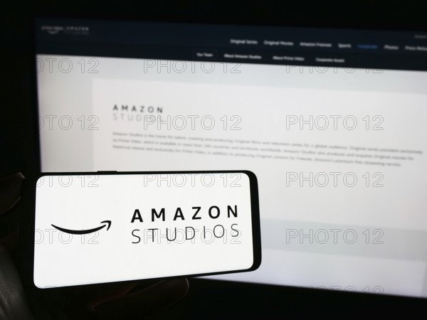 Stuttgart, Germany, 11-08-2023: Person holding smartphone with logo of US film and television