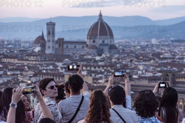 FLORENCE, ITALY, SEPTEMBER 21, 2023, Large tourist crowd on Piazzale Michelangelo enjoying sunset