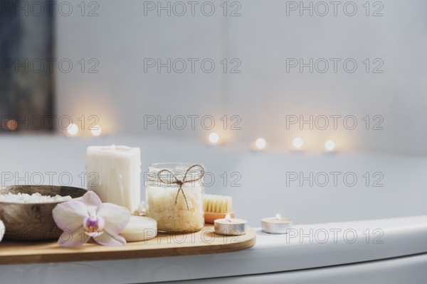 Preparation for hotel spa treatment or home bath procedure. White washbasin in bathroom with