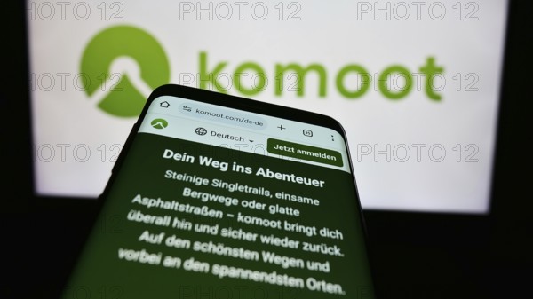 Stuttgart, Germany, 05-23-2024: Cellphone with web page of German route planning app company komoot