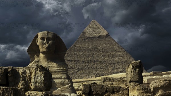 Great pyramid and sphinx and dark storm clouds in Giza Cairo, Egypt, Africa