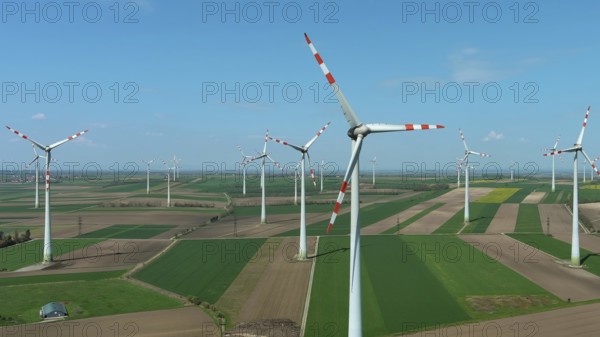 Aerial view of wind turbines and agriculture fields. Windmills turbines generating electricity,