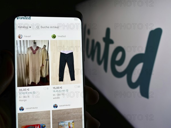 Stuttgart, Germany, 03-17-2024: Person holding cellphone with webpage of online secondhand