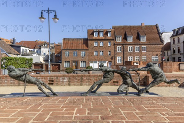 Walled-up ground plan of the former St Mary's Church and sculpture Tug of War - The Strongest by