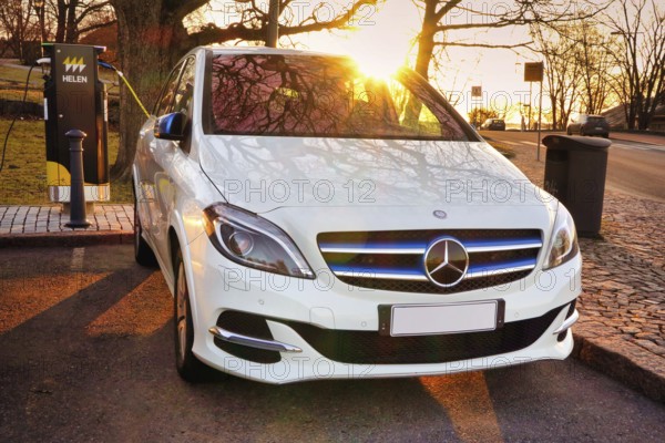 Mercedes-Benz B-Class Electric Drive electric car plugged in at public HELEN charging point.