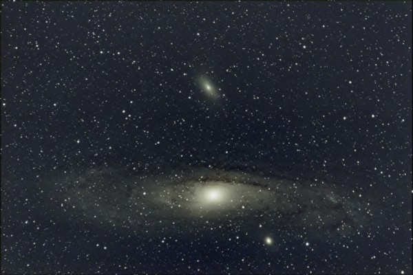 An impressive close-up of a large spiral galaxy (M 31, Andromeda Nebula) surrounded by countless