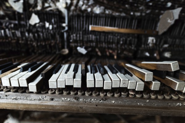 Detail of broken grand piano in mess hall of abandoned military base in Chernobyl Exclusion Zone of
