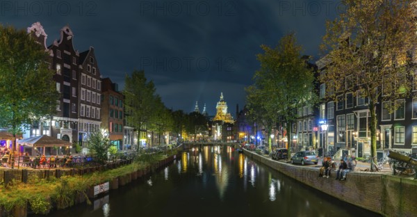 A picture of the Red Light District and the Basilica of Saint Nicholas in the distance, at night,