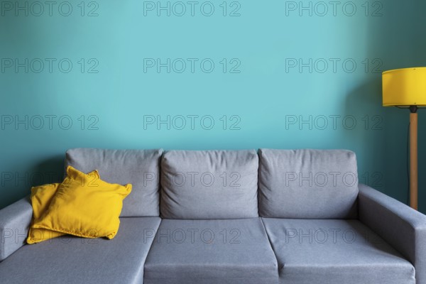 Luxury living room template with modern interior design, turquoise empty wall, gray sofa, yellow
