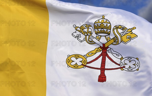 Close-up of the national flag of the Vatican State, fluttering in the wind with folds, wave