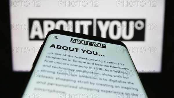 Stuttgart, Germany, 03-14-2023: Smartphone with webpage of German e-commerce company About You SE