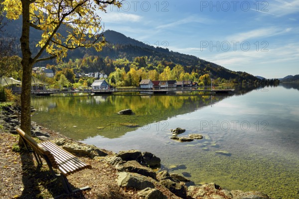 Lakeside path and boathouses on the autumnal large Alpsee lake near Bühl, Immenstadt Im Allgäu,