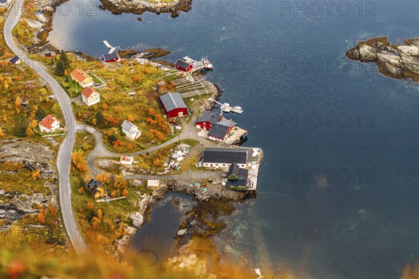 Aerial view of a small island village surrounded by a vibrant autumn landscape, mountains, rocks,
