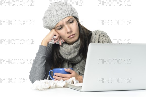 Close up Tired Sick Woman in Gray Winter Attire Working with Her Laptop While Having Cup of hot tea