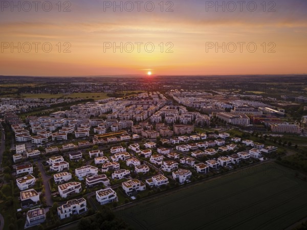 The sun rises behind the Riedberg district of Frankfurt. (Aerial photo with a drone), Germany,