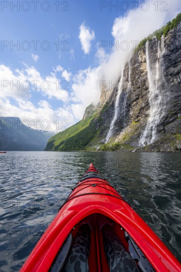 Kayak trip on the Geirangerfjord at the waterfall The Seven Sisters, tip of a red kayak in the