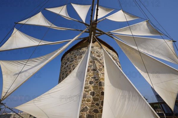Wide sails on a stone windmill, blue sky in the background, windmill, Antimacheia, Kos, Dodecanese,