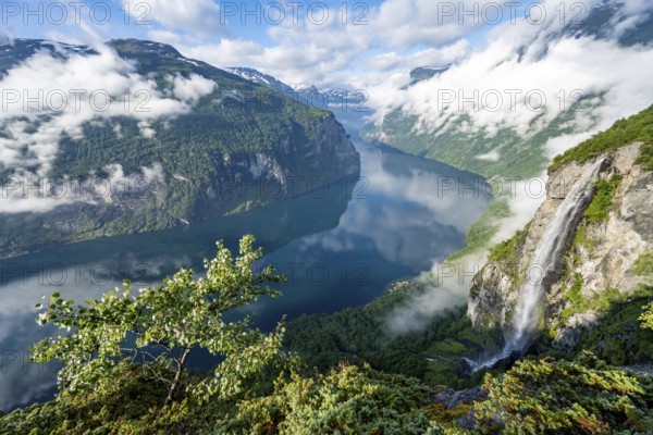 Gjerdefossen waterfall, at Ørnesvingen viewpoint, atmospheric clouds over the fjord in the morning