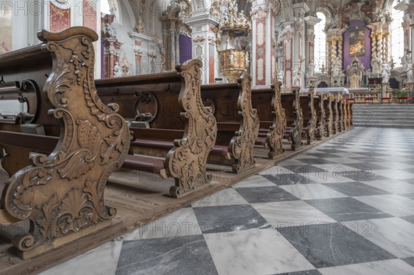 Artfully carved cheeks of the church pews in the collegiate basilica, Neustift St Margarethen,