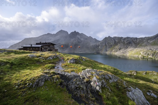 Mountain hut Wangenitzseehütte in the morning light, mountain landscape with mountain lake