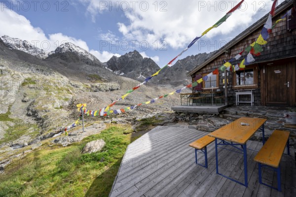 Colourful prayer flags, terrace at a mountain hut, mountain hut Adolf-Nossberger-Hütte, mountain