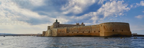 Castello Maniace, Maniace sea fortress, large Mediterranean fortress under a cloudy sky on the