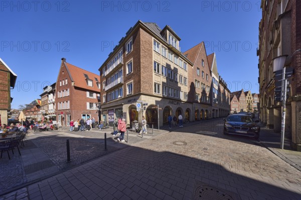 City centre, pedestrian zone, general architecture, brick buildings, parking lane with vehicles,