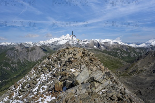 Böses Weibl summit with summit cross and colourful prayer flags, view of picturesque mountain