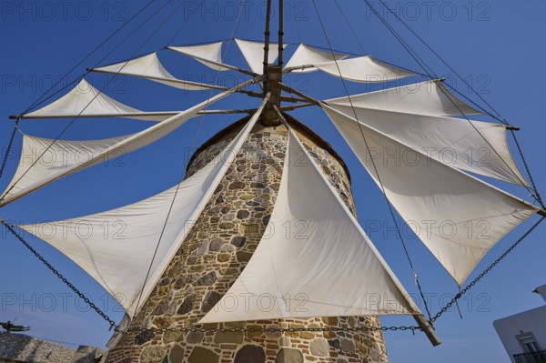 Sails of a stone windmill unfurl under a clear sky, Windmill, Antimacheia, Kos, Dodecanese, Greek