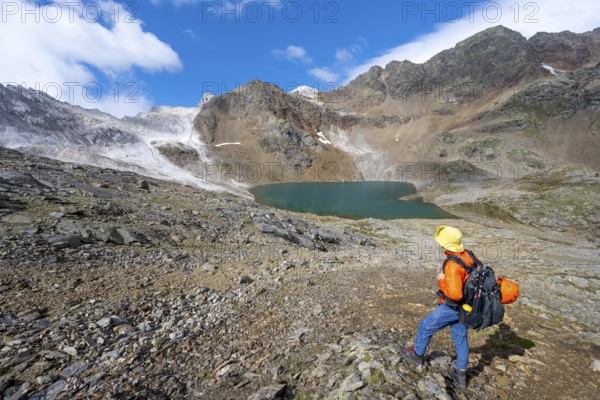 Mountaineer in front of mountain landscape with limestone rocks between granite mountains, mountain