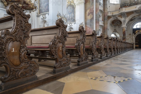 Decoratively carved cheeks of the lay pews in the baroque Basilica of St Alexander and St Theodore,
