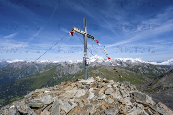 Böses Weibl summit with summit cross and colourful prayer flags, view of picturesque mountain