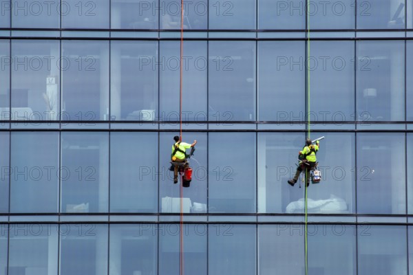Detroit, Michigan - Window washers at the 25-story Residences Water Square luxury apartment