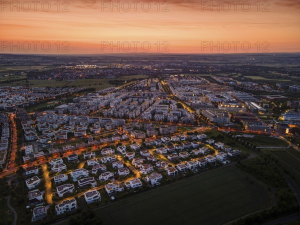 Dawn behind the Riedberg district of Frankfurt heralds the imminent sunrise. (Aerial view with a