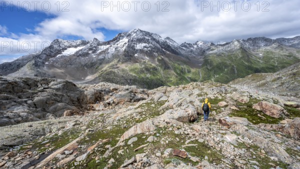 Mountaineer on hiking trail, rocky mountain landscape, behind mountain peak Roter Knopf with fresh