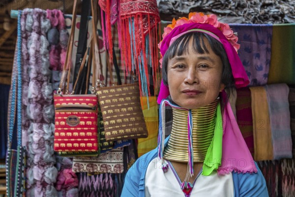 Tribal woman selling woven scarves and other crafts in the Long Neck Karen tribe (more properly