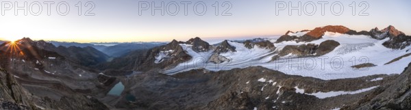 Panorama at sunrise with sun star, high mountain landscape, view of blue glacial lakes, mountain