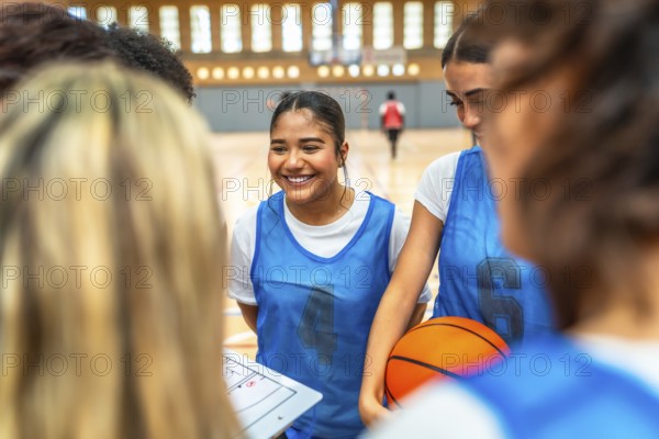 Happy basketball players gathering in a gym, discussing game strategies and fostering teamwork