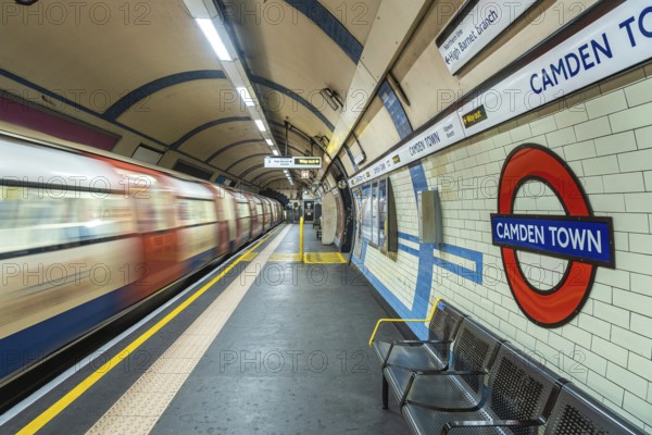 Motion blur of a london underground train arriving at camden town station with its distinctive