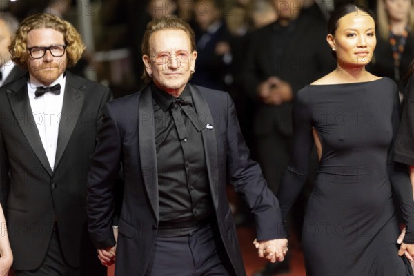 Cannes, France - 16.5.2024: Erik Messerschmidt, Bono, Kelly McNamara on the red carpet during the