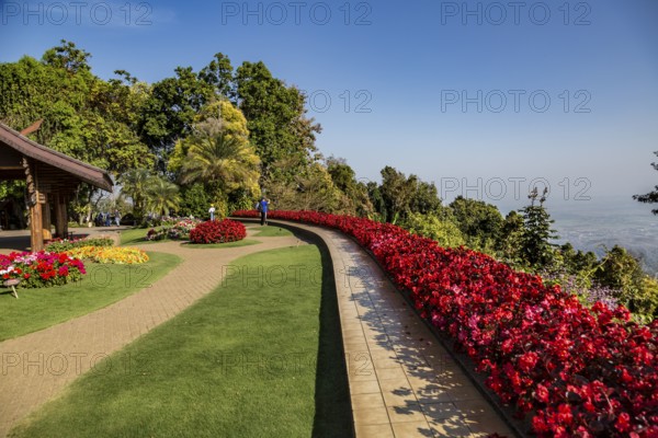 Colorful lush flower gardens line the perimeter of the mountain top Doi Tung Royal Villa lawn with