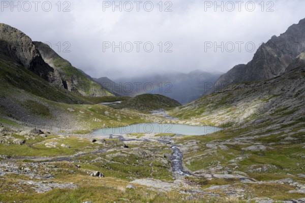 Turquoise-blue mountain lake Mittersee and rainbow, Schober group, Hohe Tauern National Park,
