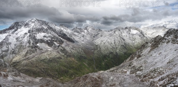 View of steep rocky mountain landscape with fresh snow in summer, in the Hornscharte, on the Wiener