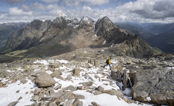 Mountaineer in rocky mountain landscape, descent from the summit of Keeskopf, behind summit of