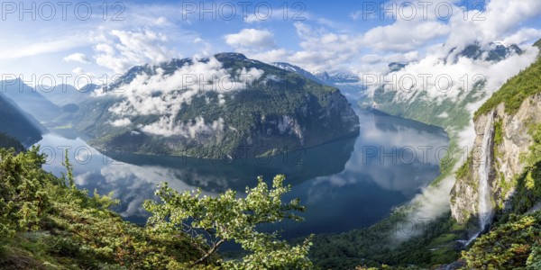 Panorama over the Geirangerfjord, Gjerdefossen waterfall, at Ørnesvingen viewpoint, atmospheric
